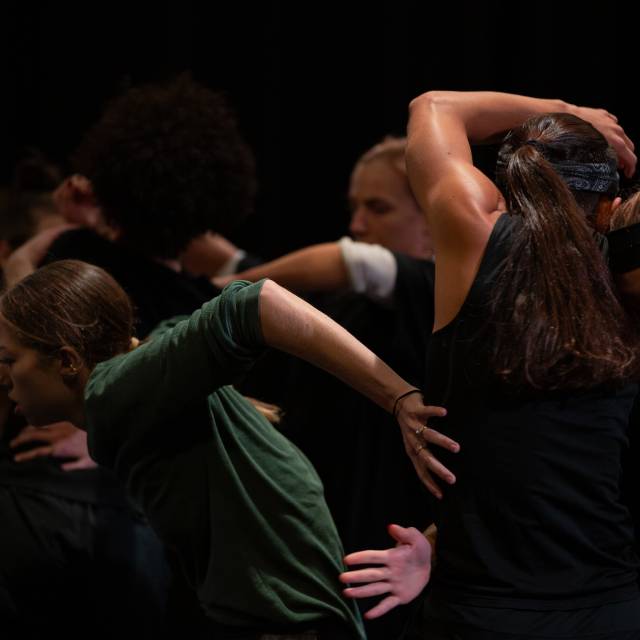 Group of 6 dancers with bodies and arms intertwined
