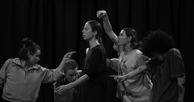 black and white image of person in mid step while 6 dancers point to a body part